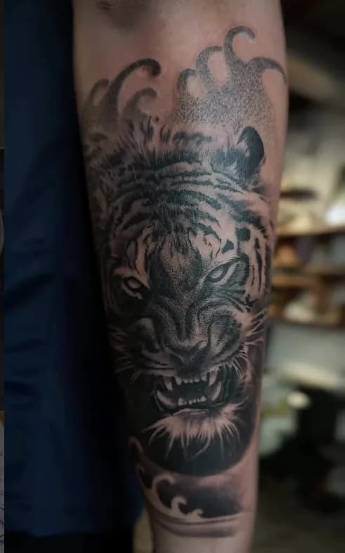 Black-and-grey tattoo close-up under studio lighting